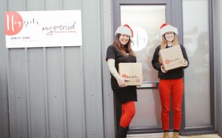 dispatch team members in front of Hey Girls building