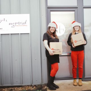 dispatch team members in front of Hey Girls building