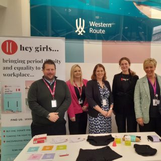 Network Rail staff with Hey Girls displaying a range of period products