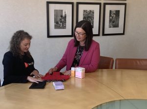 Two people sat at a table looking at Hey Girls period pants