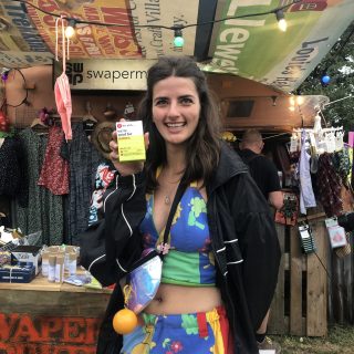 girls holding a hey girls menstrual cup on Glastonbury Swapermarket