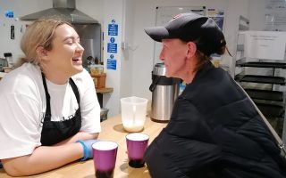 two woman having a pleasant conversation over a cup of tea or coffee