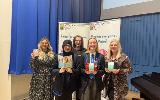 Period dignity event Hollyrood school - group photo with people holding hey girls products